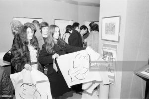 A Group of Anarchists who object to John Lennon's BAG ONE exhibition of original lithographs invaded the London Arts Gallery in New Bond Street, London and offered copies of some of the pictures to visitors for 6 pounds each, Saturday 24th January 1970. The original 'works' would cost over 40 pounds. For some time they took the gallery over then later stood outside giving leaflets to people entering and leaving. * Eugene Schuster, the owner of the London Arts Gallery, was charged with exhibiting 'indecent prints' under an obscure 1830 law (Cleared April 1970), said Lennon had exposed his own private sex life 'to encourage a more introspective commitment to content by today's artists who can be so timid'. (Photo by David Housden/Sunday Mirror/Mirrorpix/Getty Images)